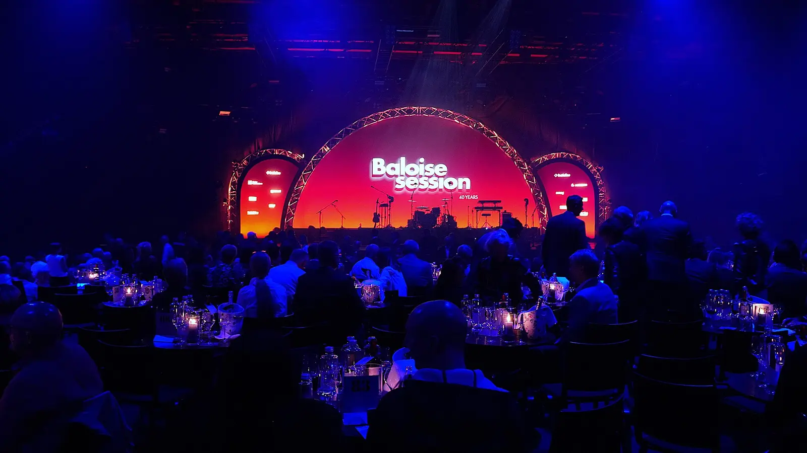 Baloise Session stage glowing red above a seated audience in Basel