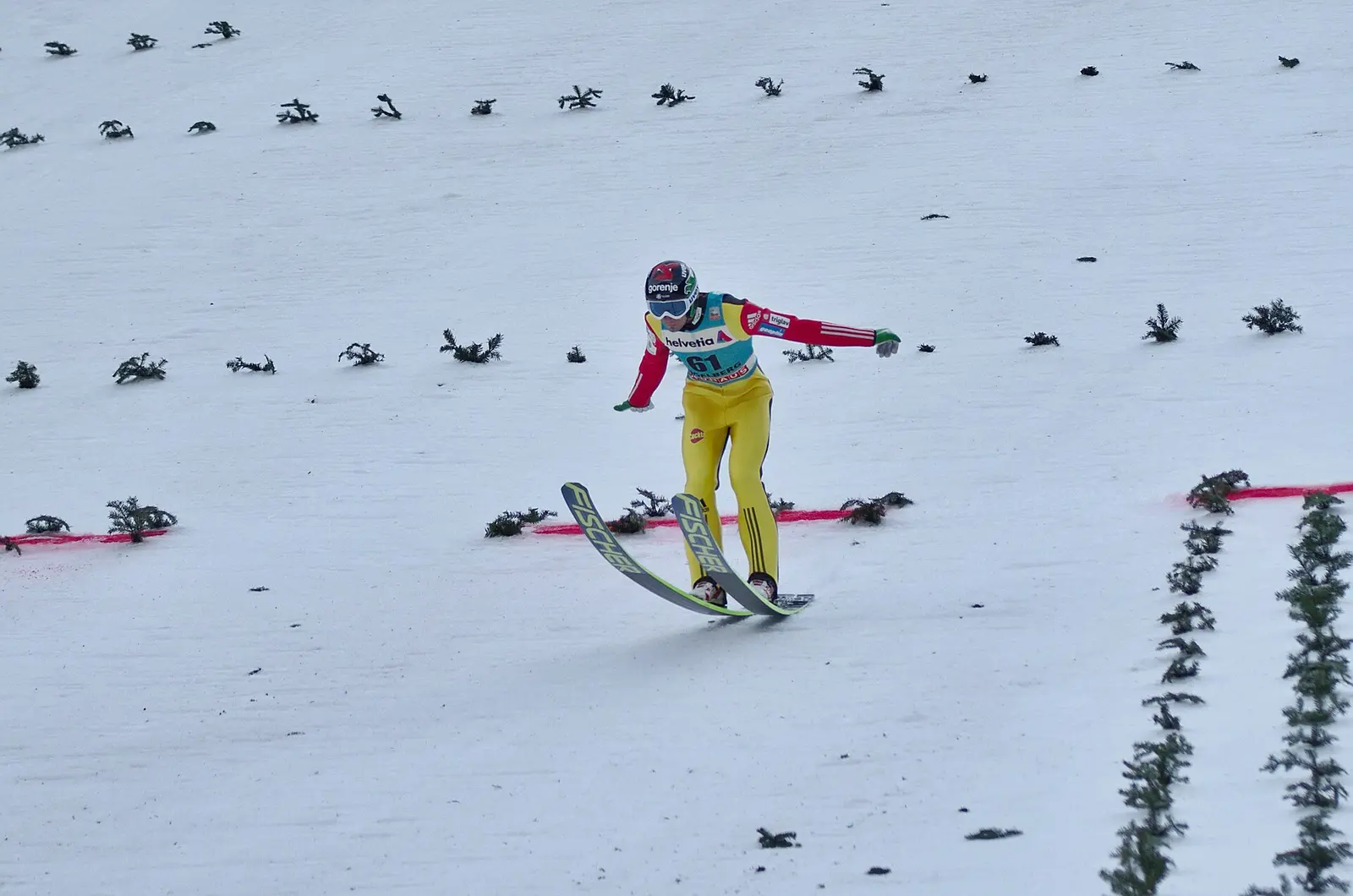 A ski jumper in flight above the landing slope at Engelberg