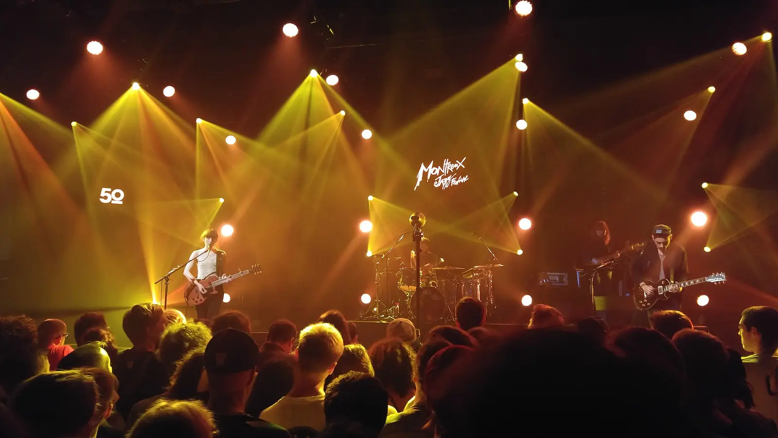 Band on a lit stage in front of an audience at the Montreux Jazz Festival