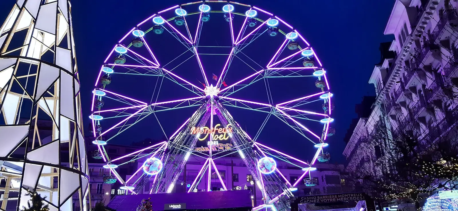 Illuminated Ferris wheel at the Montreux Christmas market at dusk