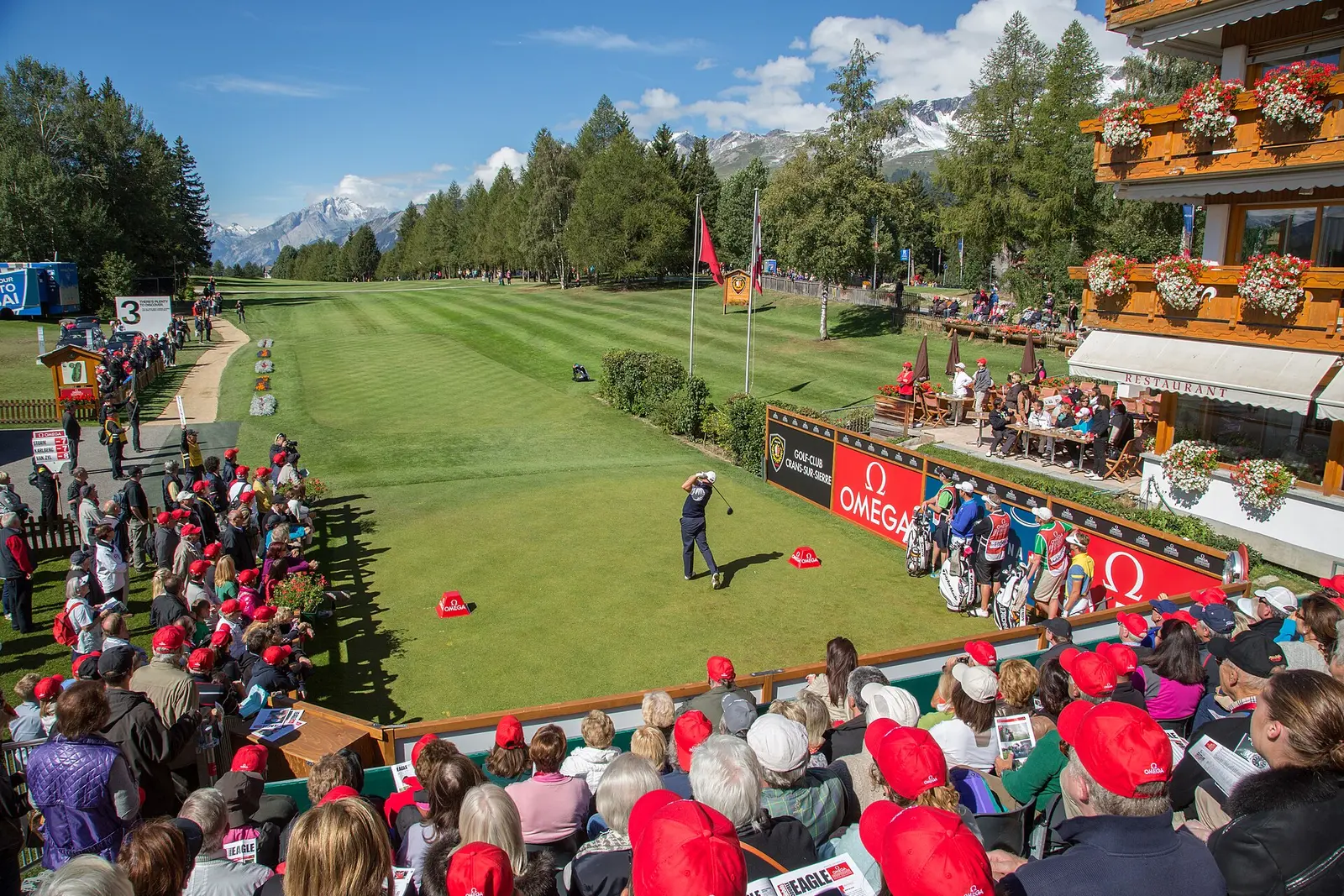 Golfers and spectators at a tee at the Omega European Masters in Crans-Montana