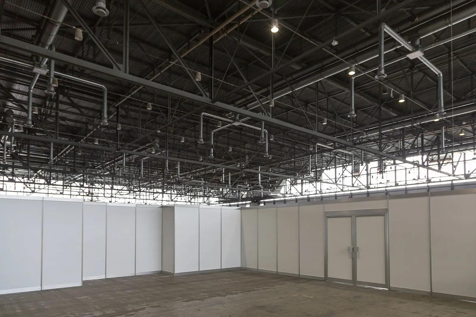 Empty exhibition hall at Palexpo in Geneva with steel roof trusses
