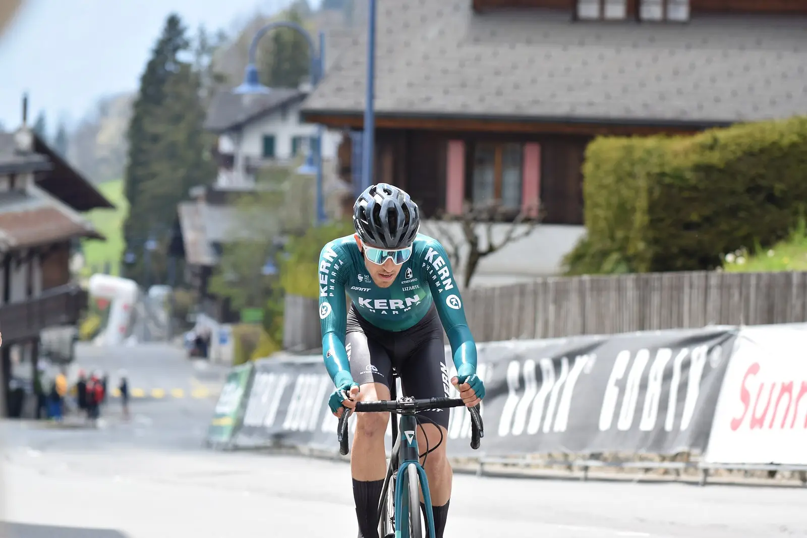 Cyclist riding through the village of Villars at the Tour de Romandie