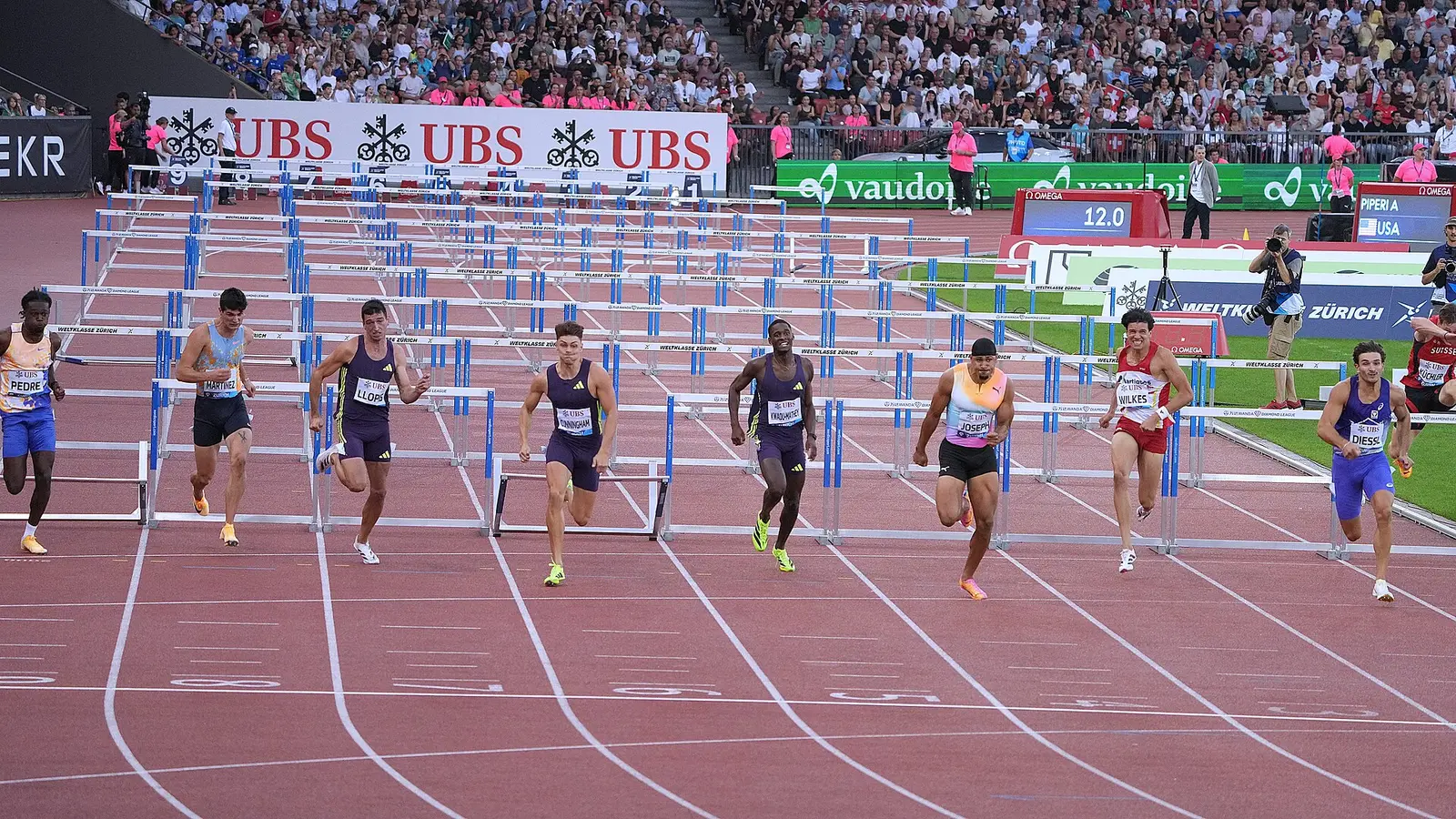 Hurdlers racing down the track at Letzigrund Stadium during Weltklasse Zurich